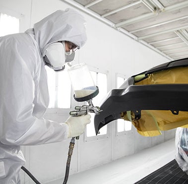 Collision Center Technician Painting a Vehicle | Sloane Toyota of Malvern in Malvern PA