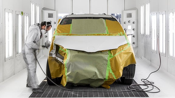 Collision Center Technician Painting a Vehicle | Sloane Toyota of Malvern in Malvern PA