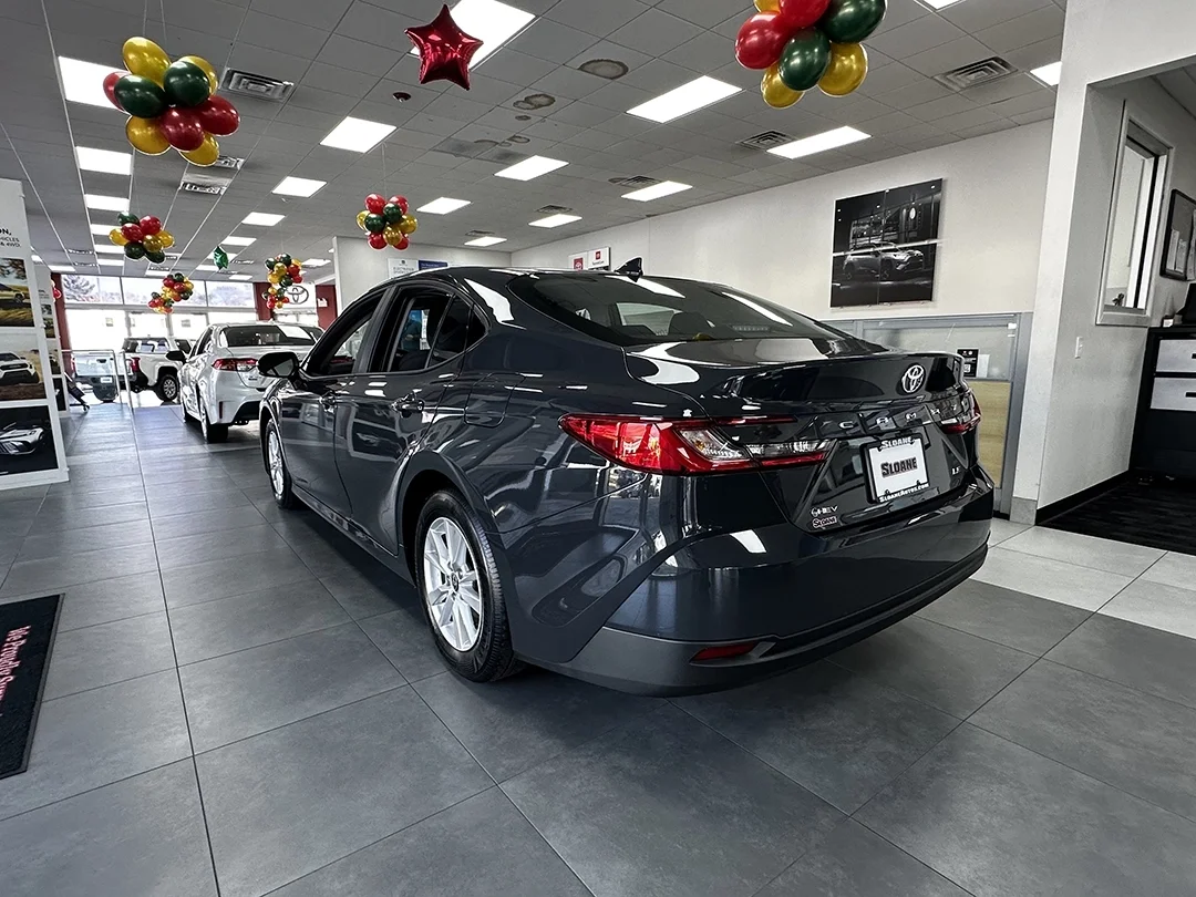 Rear view of a 2026 Toyota Camry SE in Midnight Black at Sloane Toyota.