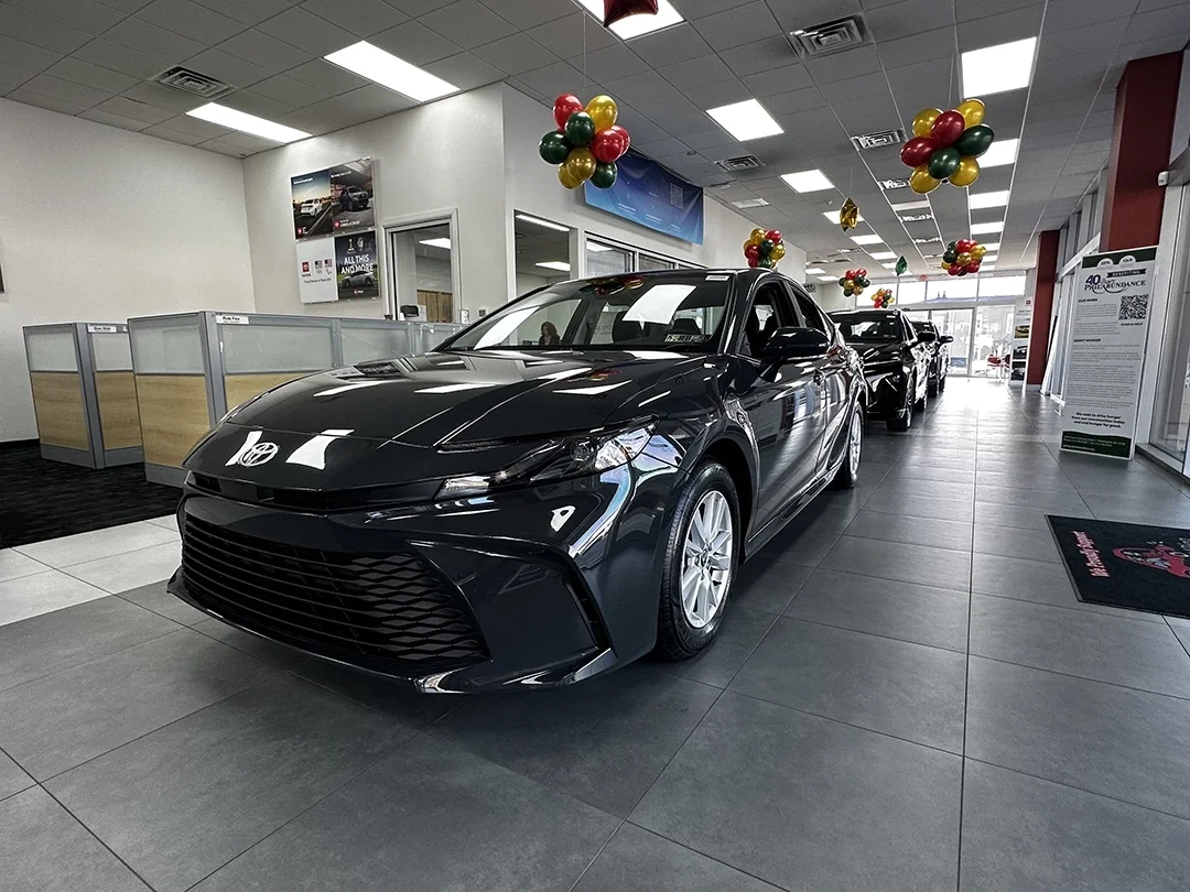 Front view of a 2026 Toyota Camry LE in Midnight Black at Sloane Toyota.